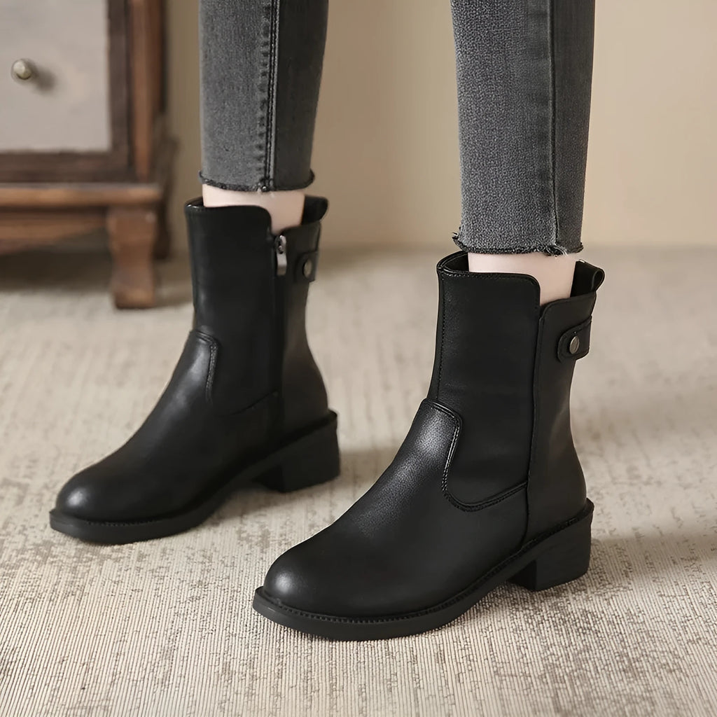 Black women's short boots with side zip and round toe on a low rubber sole.