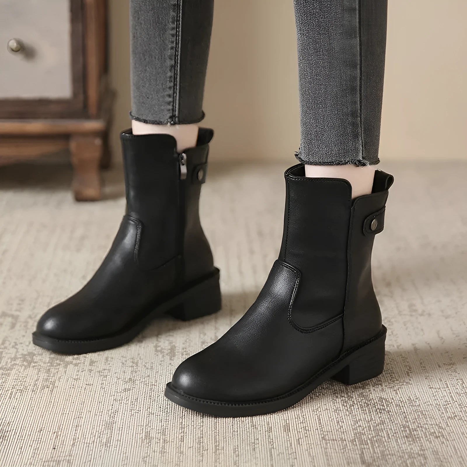 Black women's short boots with side zip and round toe on a low rubber sole.