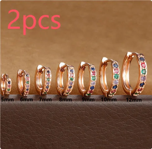 Geometric circle zircon perforated stud earrings in gold, rose gold, and silver colours showing perforated pattern detail