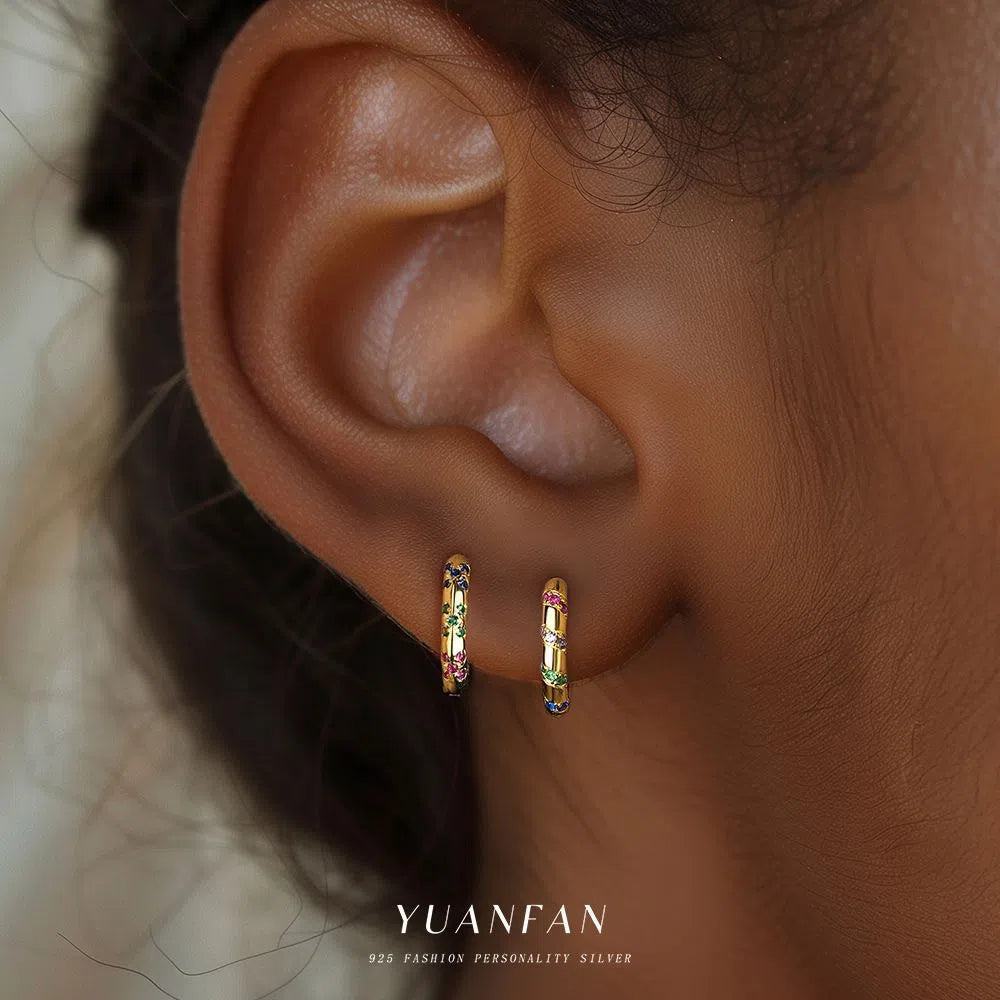 S925 sterling silver geometric earrings with yellow gold finish and inlaid zircon stone on white background
