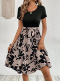 Women's khaki A-line casual dress with floral printing and lace-up front detail.