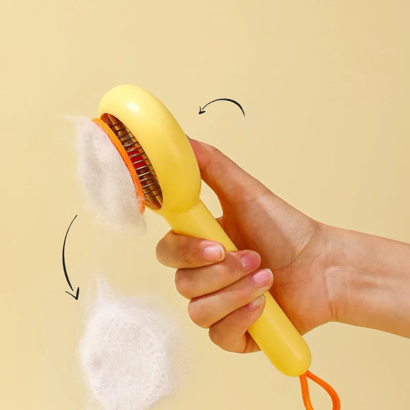 Small yellow duck-shaped comb for pet grooming with needle points and floating hair removal device