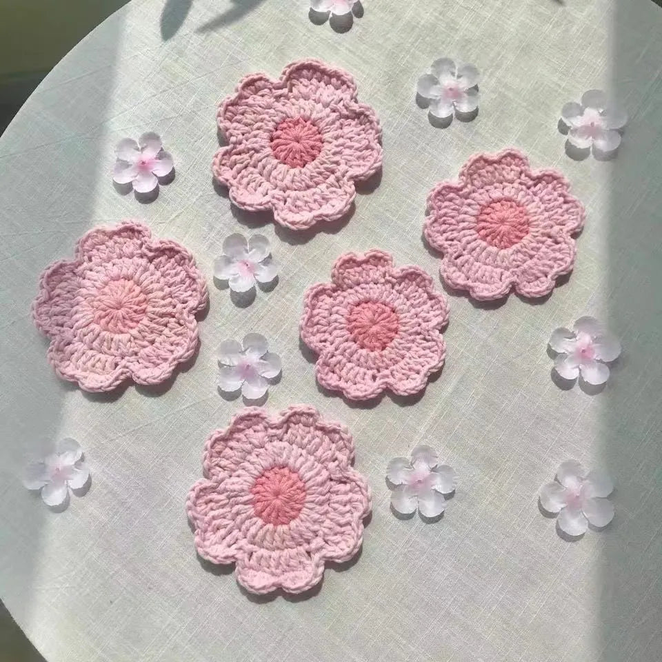 Set of hand-woven wool coasters on a wooden table surface
