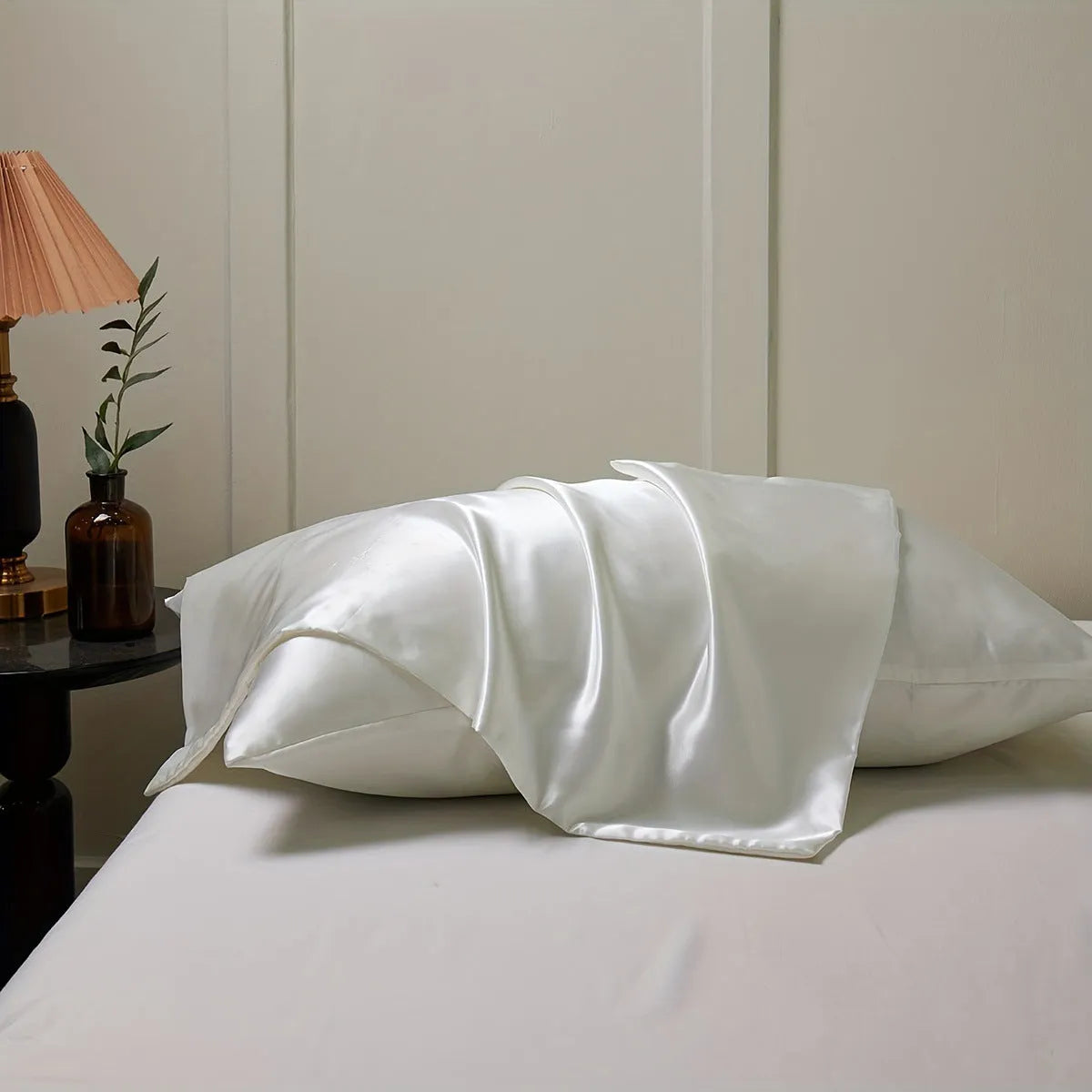 Pair of solid colour satin cloth pillowcases showing colour options including navy blue, wine red and light pink