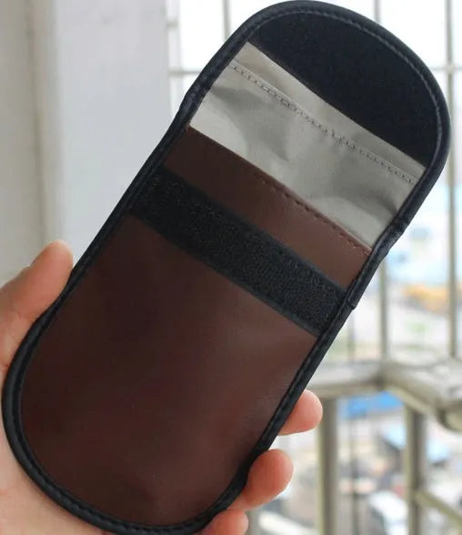 Black microfiber Faraday cage car key signal blocker case measuring 13.5 by 9.5 centimetres.