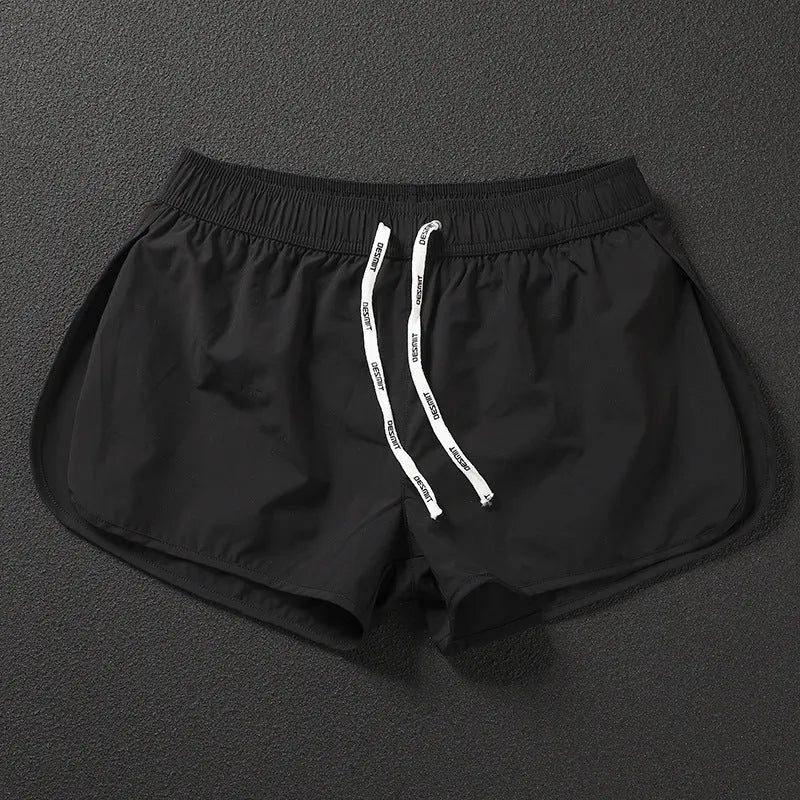 Men's loose fit beach shorts in fluorescent green, orange red, and black colours with micro-elastic polyester fabric