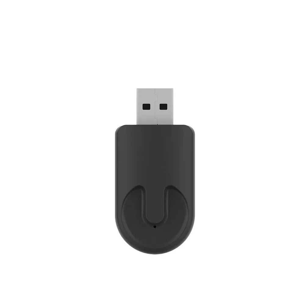 Small black wireless CarPlay USB adapter with compact rectangular design.