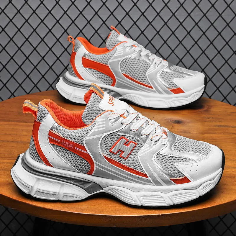 Men's white and grey mesh running shoes with a round toe and plastic sole on a plain background.