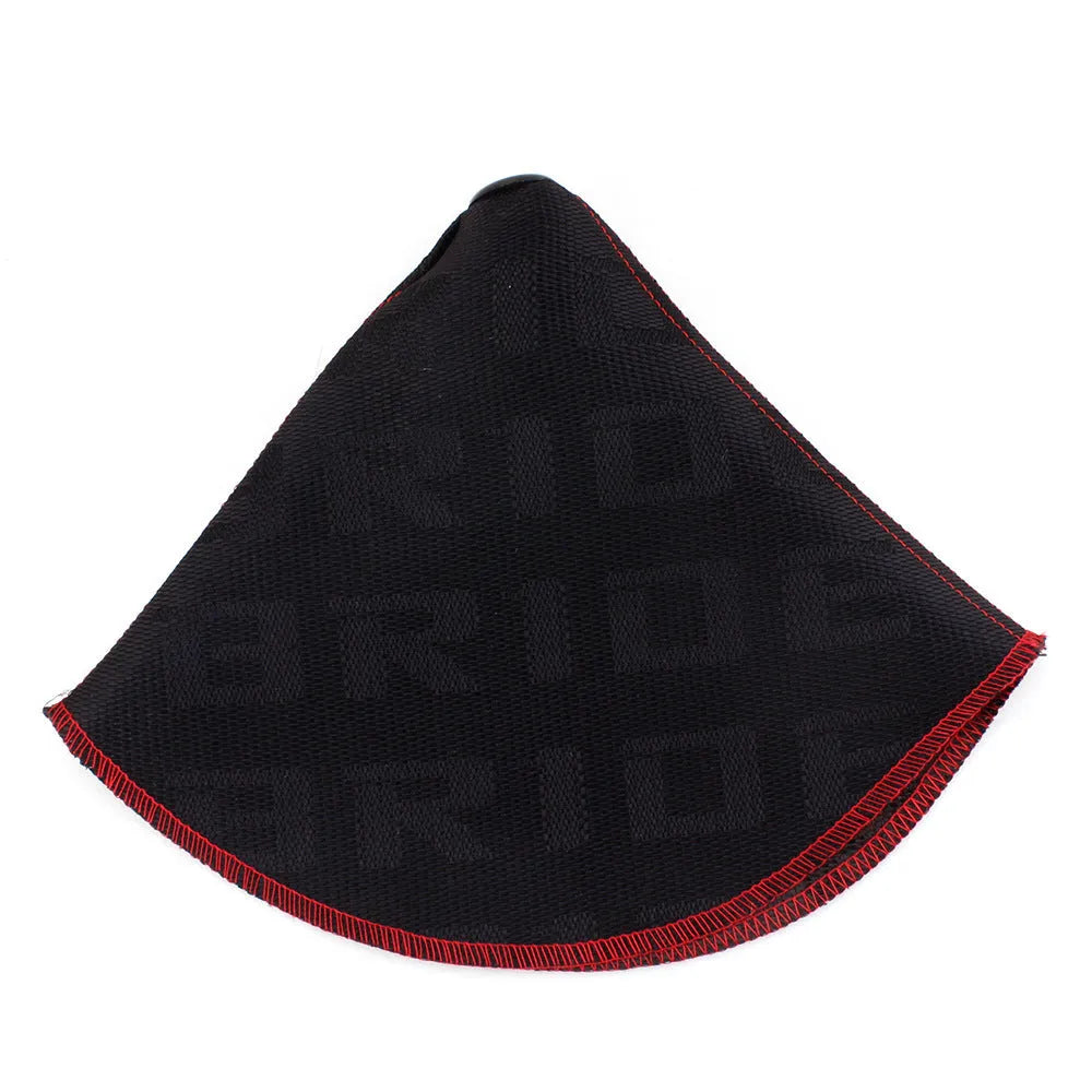 Canvas dust cover draped over a racing bucket seat in a vehicle interior.