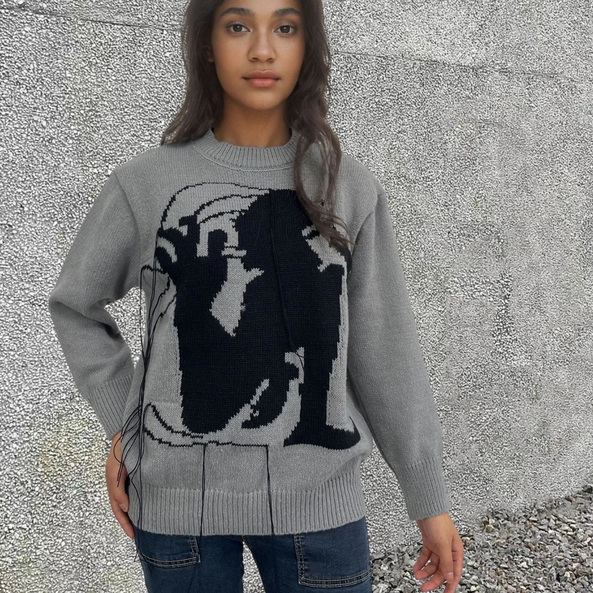 Grey women's loose alpaca wool sweater with tassel detail and abstract pattern, round neck.