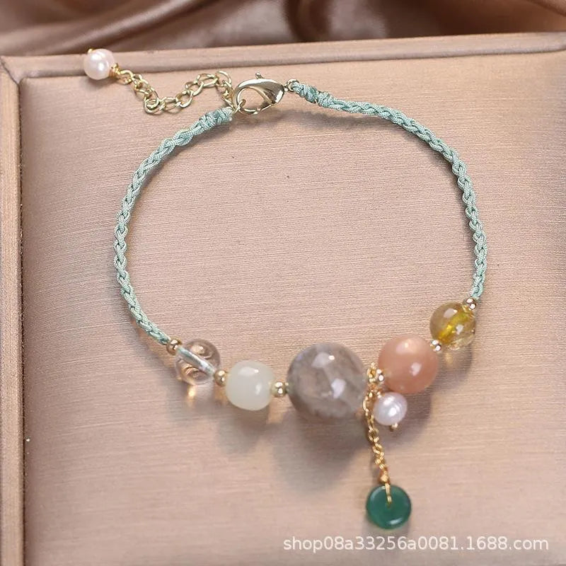 Women's hand-woven bracelet with peace buckle closure and crystal sequins in red, green, and blue colour options
