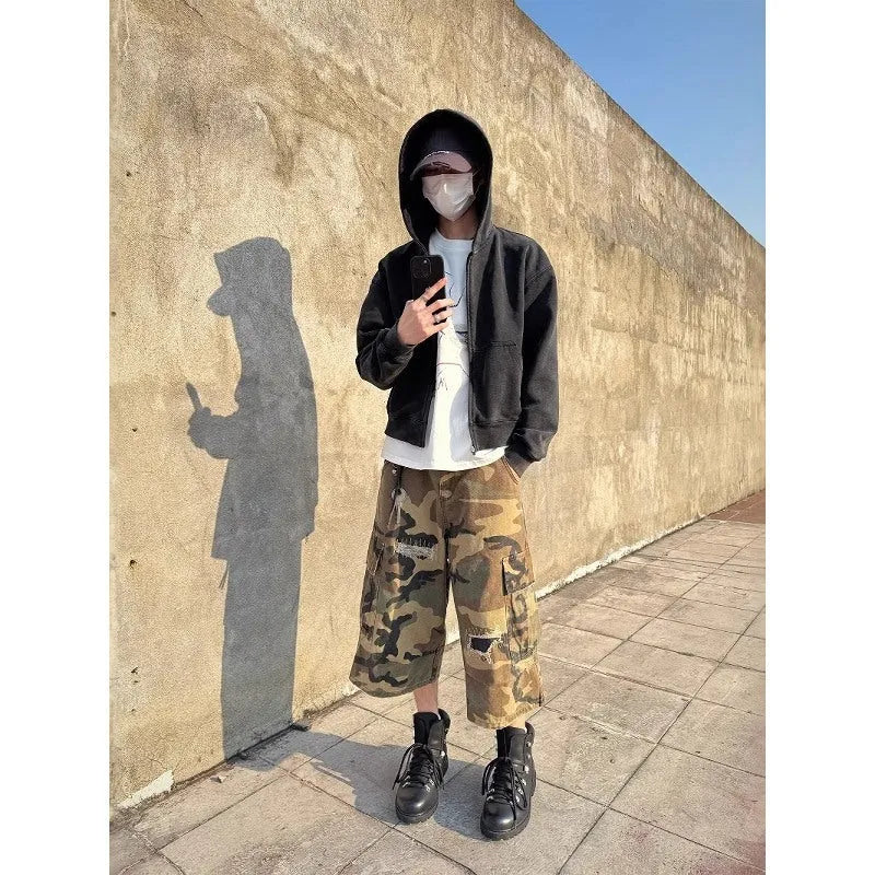 Men's camouflage cropped jeans with distressed patch detailing and straight-leg styling