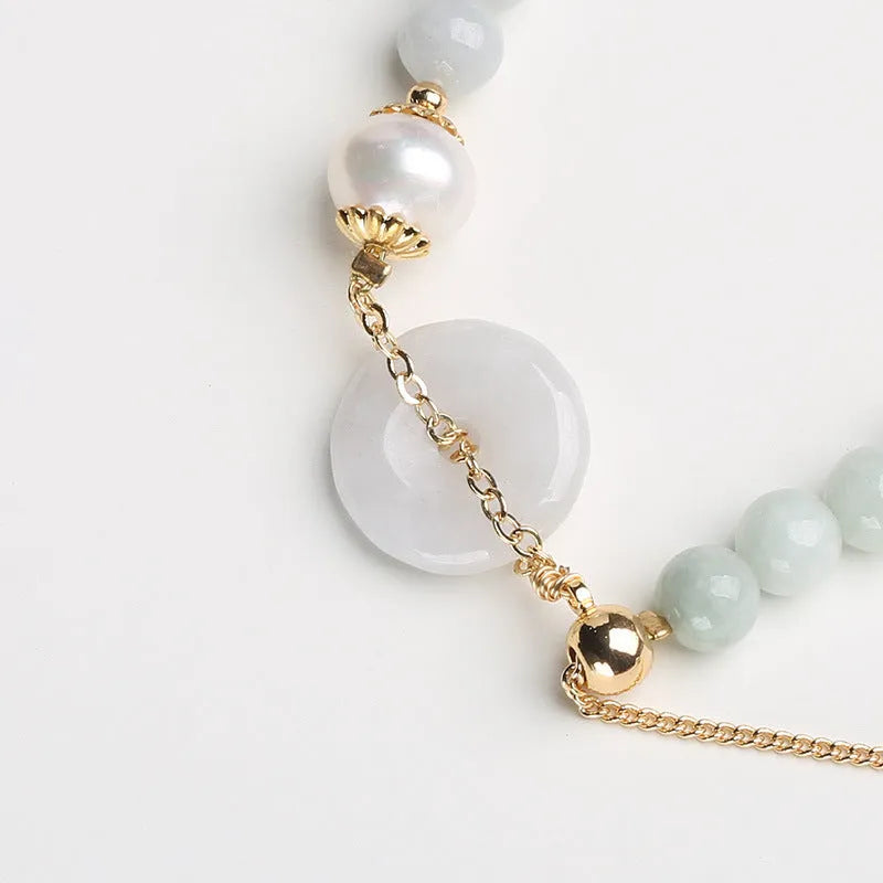 Natural emerald peace buckle pearl bracelet for women with jade round pendant on a geometric design.