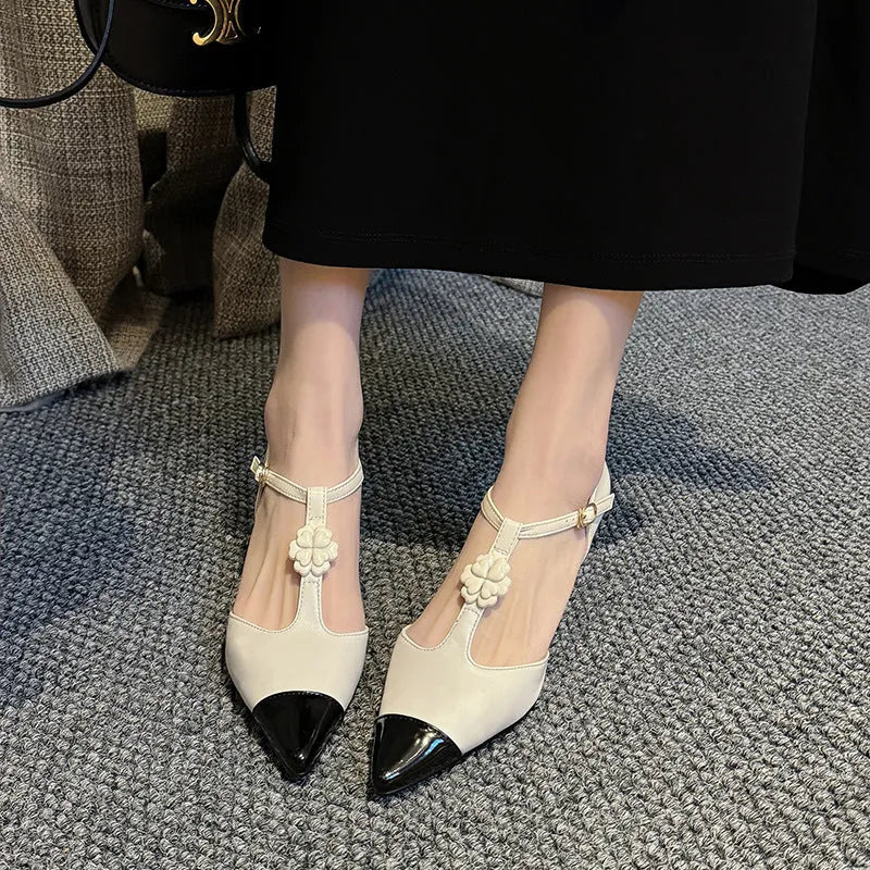 Gold women's stiletto heel shoe with floral buckle and pointed toe on a shallow 7-11cm cut.