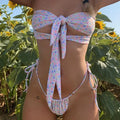 Women's lace-up back swimsuit with built-in chest pads in floral and solid colour patterns