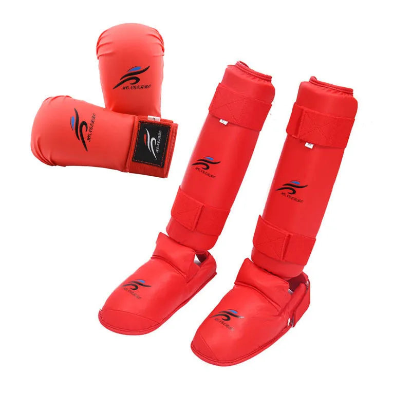 Karate protective gear set showing red leg guards, helmet and boxing gloves for martial arts training