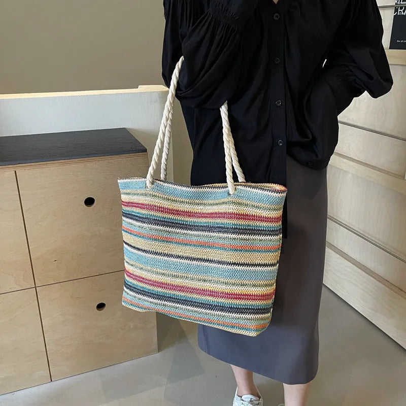 Blue straw woven nylon shoulder bag with a single strap and large main compartment