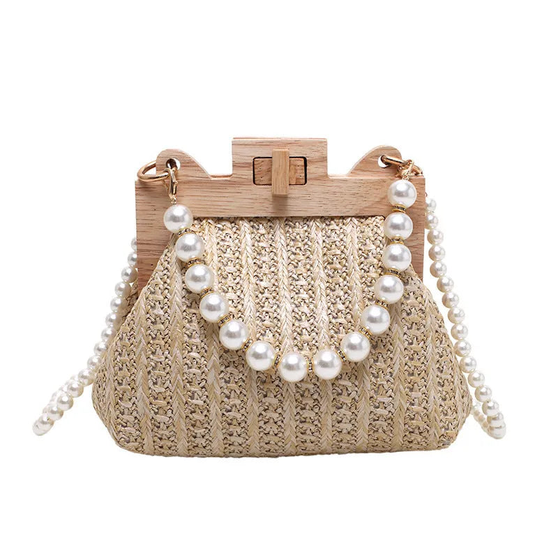 Women's woven straw shoulder bag with pearl chain strap in horizontal square shape showing sandwich pocket detail.