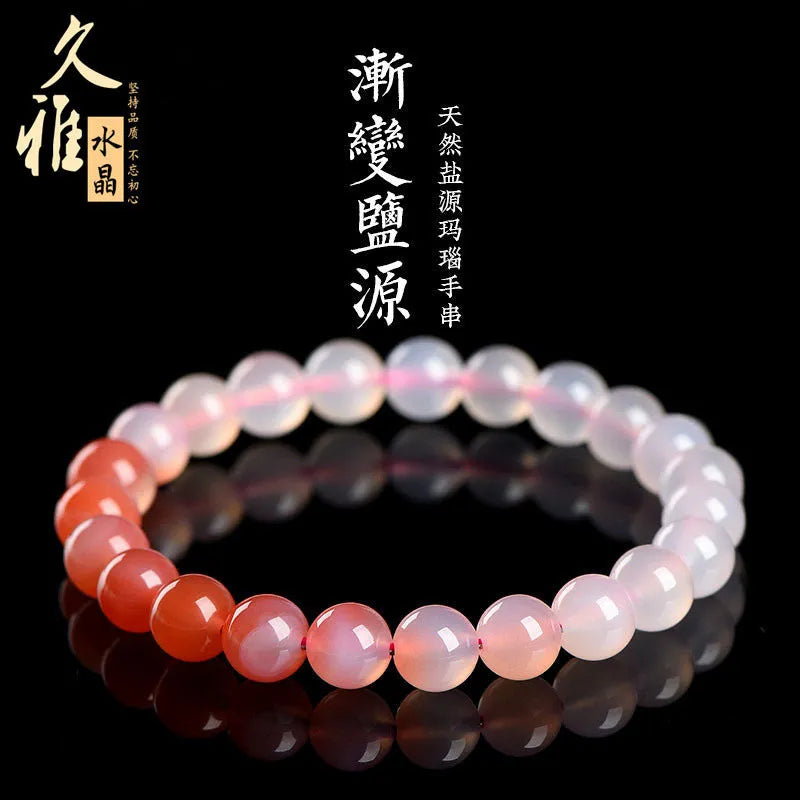 Natural gradient Yanyuan agate beaded bracelet with geometric polished beads on a wrist.