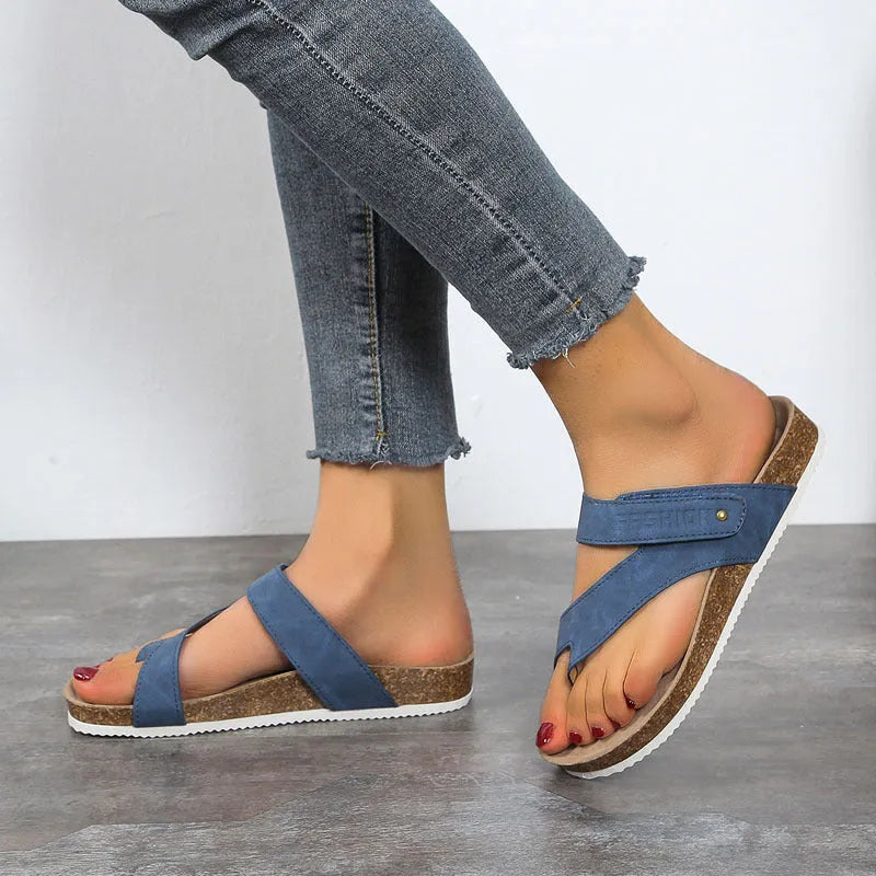 Flat toe ring thick-soled flip-flop in a solid colour on a plain background