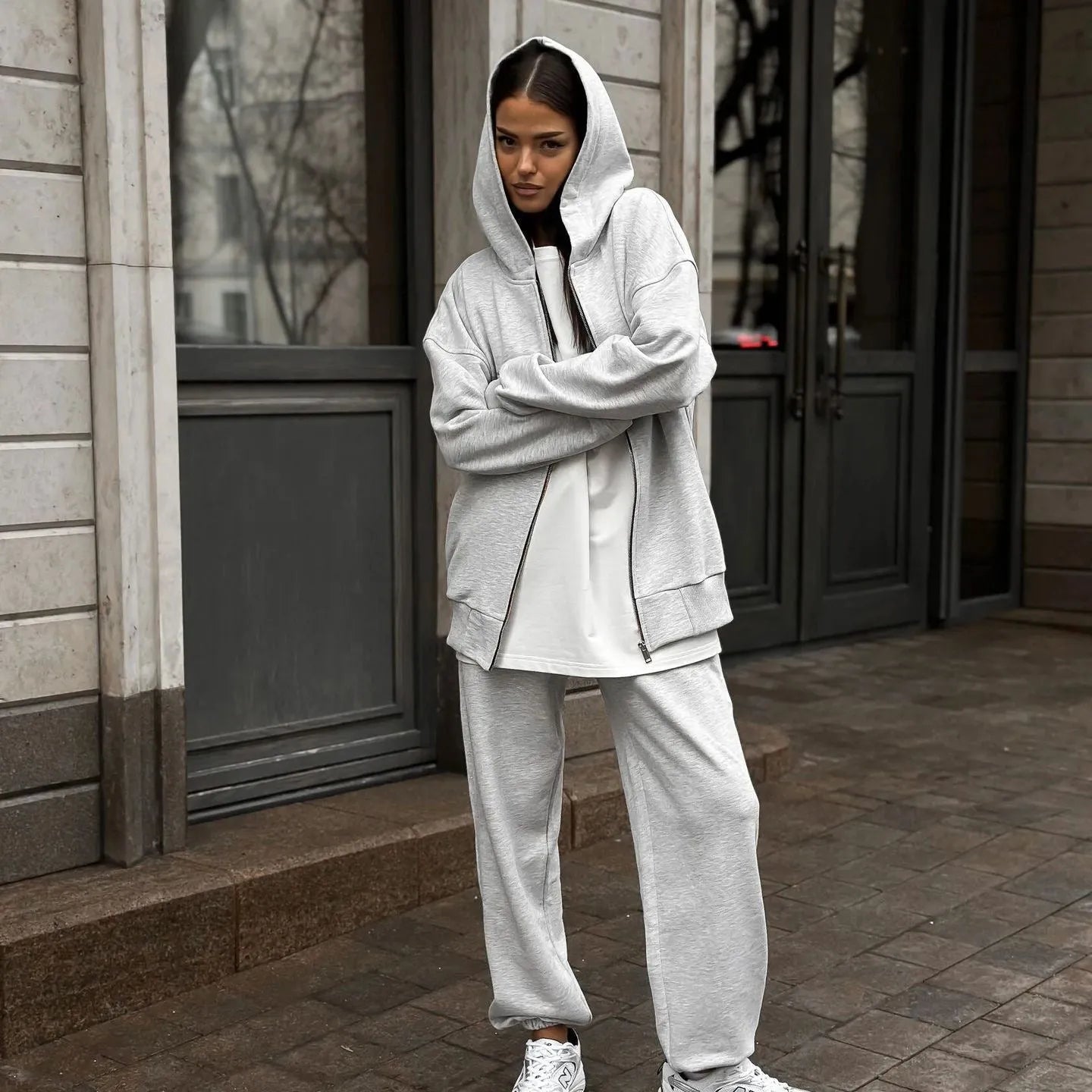 Women's red street style two-piece set with long-sleeved coat and matching trousers, loose fit.