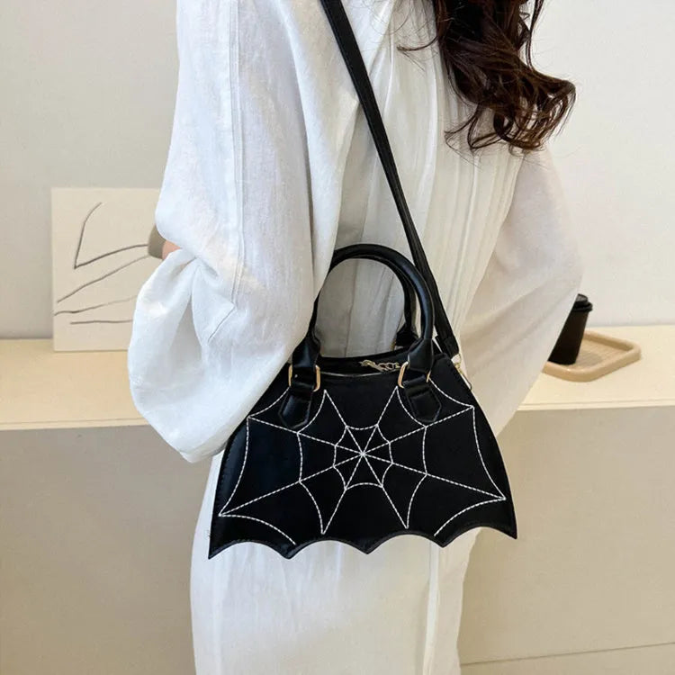Women's small square PU saddle bag with spider web pattern, crossbody strap, and top handle, available in six colours including black and red