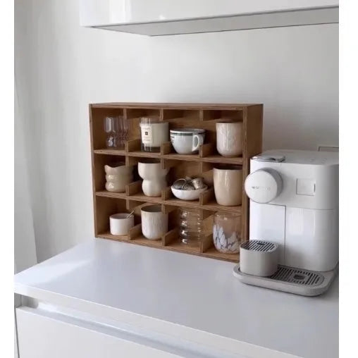 Square birch wood cup storage rack with multiple grid compartments for organising drinkware.
