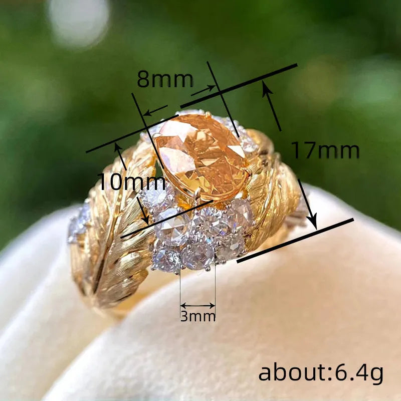 Gold colour copper women's ring with embossed feather pattern and yellow zircon stones on geometric band