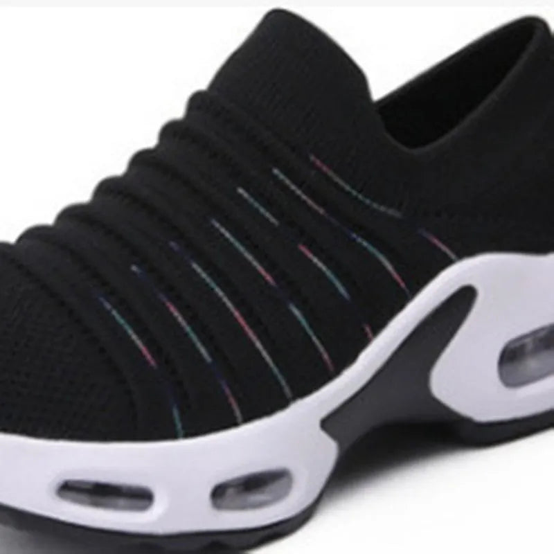 Women's fly-knit stretch sock shoes in light grey with low heel and round toe.