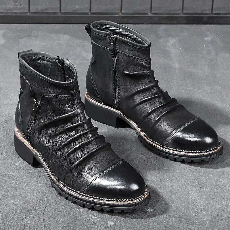 Men's black side-zip cowboy boots with a round toe and horseshoe heel on a wooden floor.