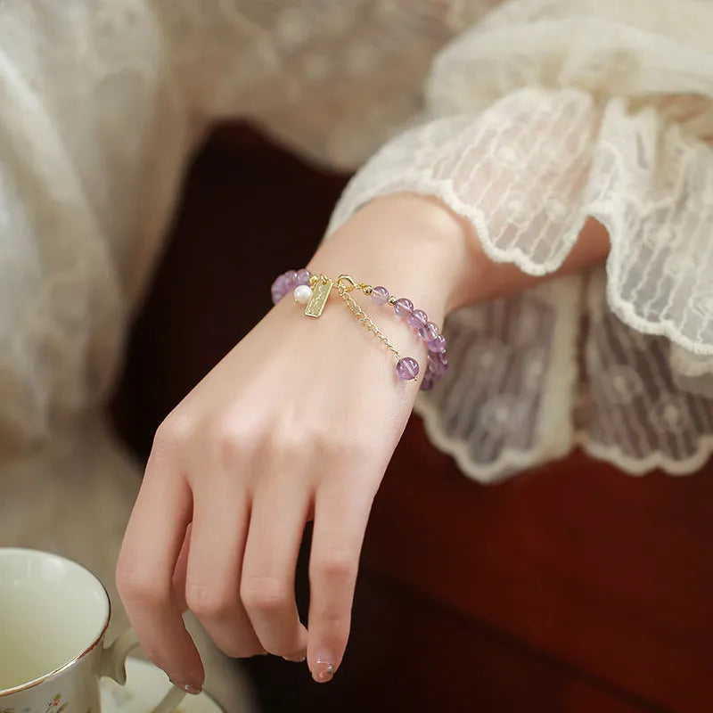 Women's natural lavender amethyst crystal bracelet showing dark and light colour options