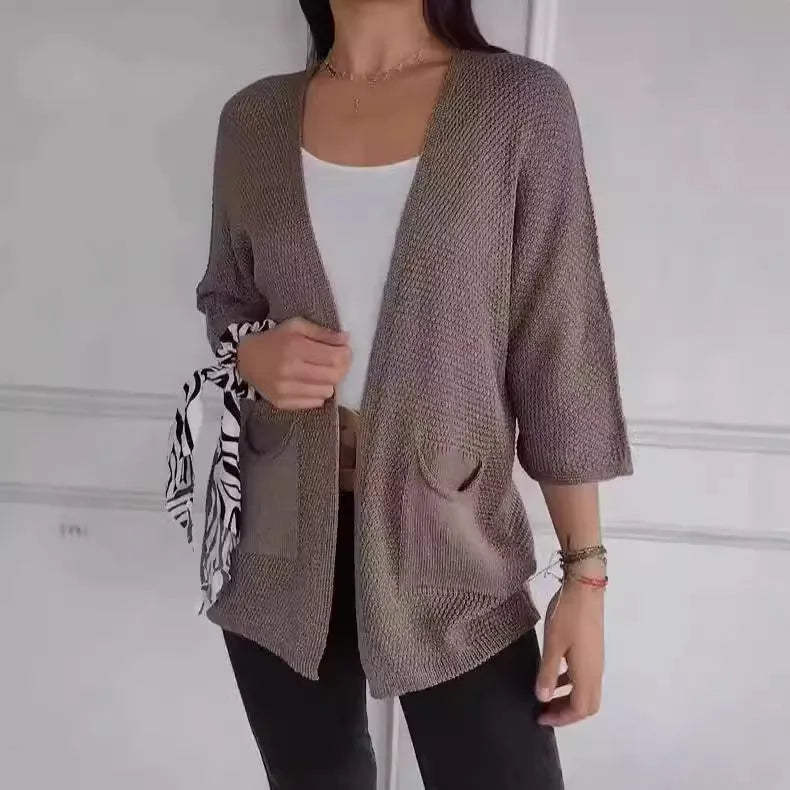 Women's army green waffle weave cardigan coat with nine-quarter length sleeves and pockets.