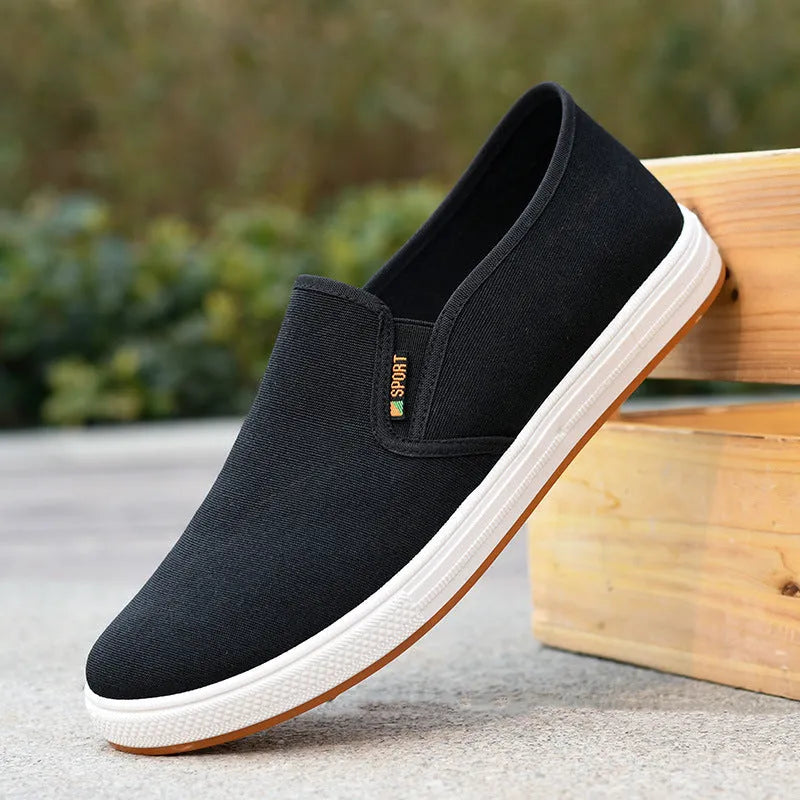 Men's black and blue canvas slip-on shoes with low-top design and round toe