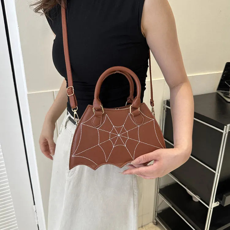 Women's small square PU saddle bag with spider web pattern, crossbody strap, and top handle, available in six colours including black and red