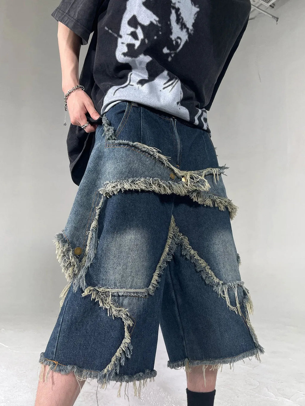 Blue denim shorts with frayed five-pointed star design and loose retro fit