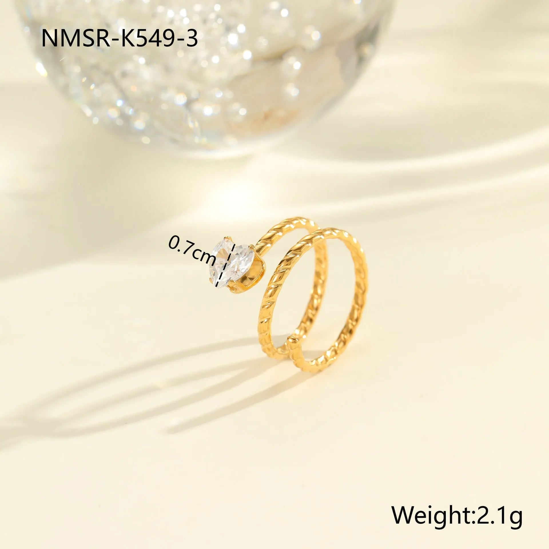 Gold-coloured adjustable stainless steel ring with zircon geometric shapes on white background.