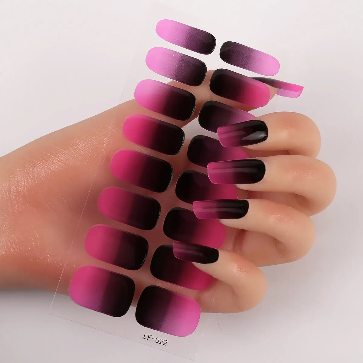 Set of 16 solid colour full nail art stickers showing patterns like cross, rose, tulip, and cartoon designs.