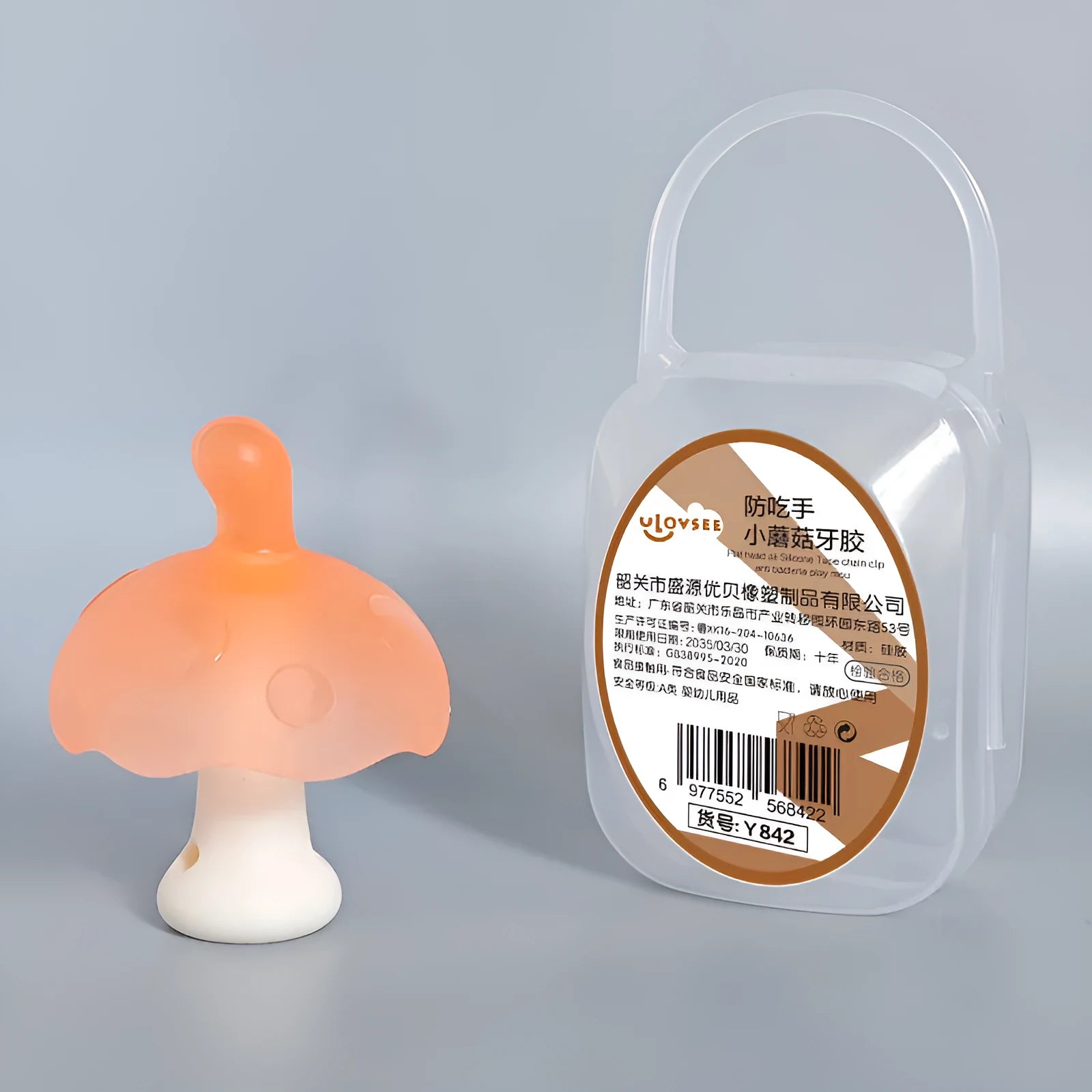 Small mushroom-shaped silicone chewing gum on a chain, in pink or nano colour, inside a transparent box.