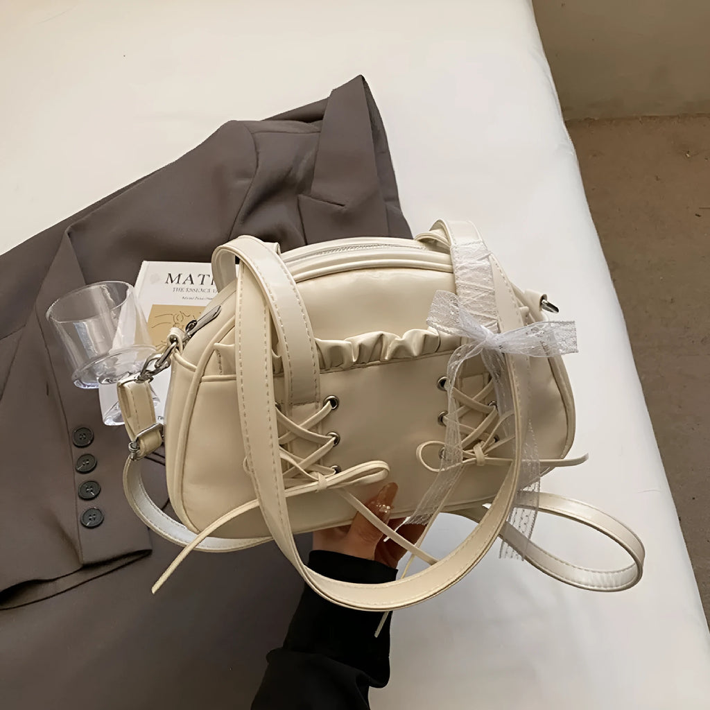 Ladies shoulder handbag with bandage bow design in PU leather showing phone pocket compartment