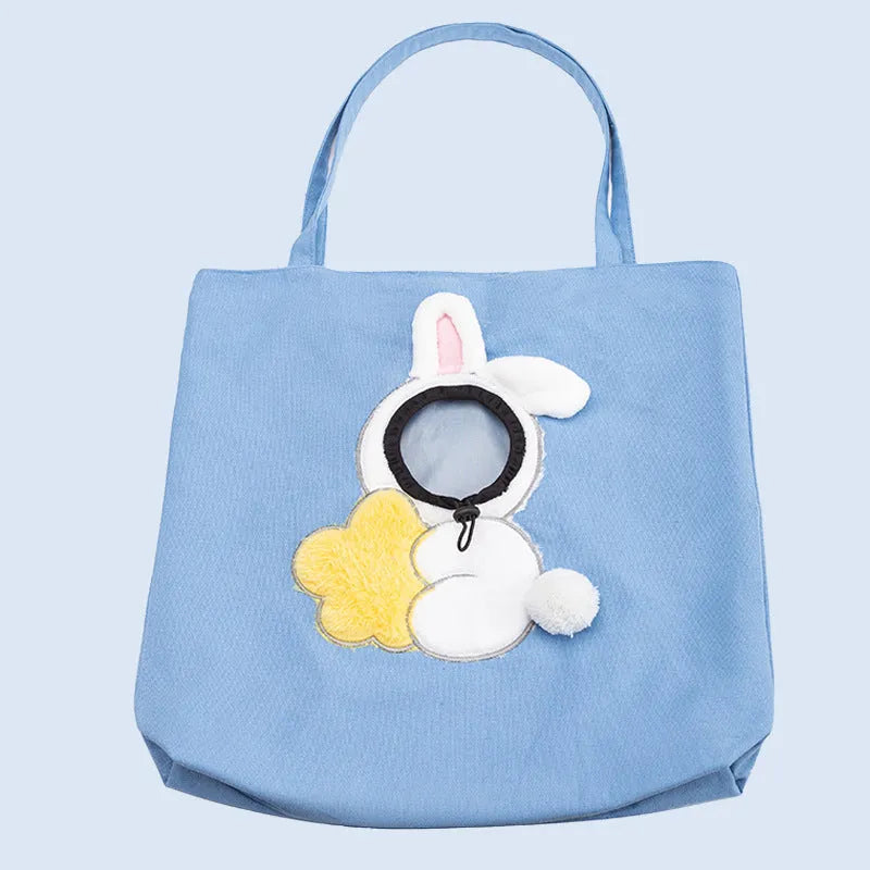 Blue canvas pet carrier bag with animal pattern, safety zippers, and side head opening for a dog