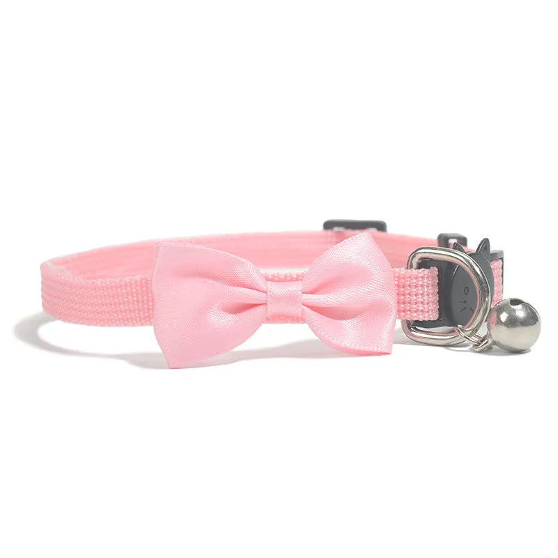 Adjustable striped nylon cat collar with a small bell, shown in multiple colour options on a white background.