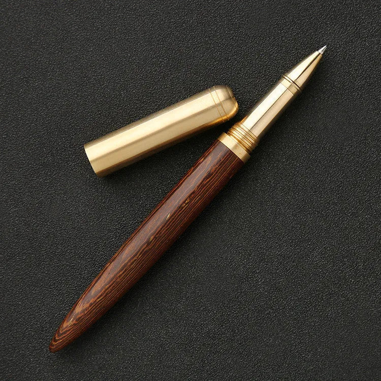 Brass and sandalwood solid wood signature pen with wooden barrel and brass fittings on a desk