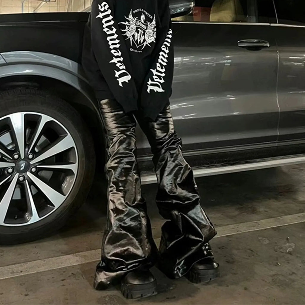 Black women's skinny jeans with a shiny patent leather finish and straight-leg cut.