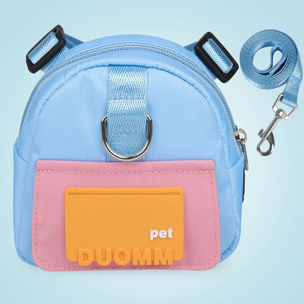 Blue adjustable dog backpack harness with storage compartment and a tow rope laid flat