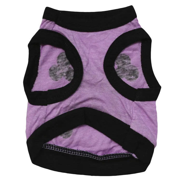 Pack of five Halloween dog vests in blue, orange, and purple with skull and bones pattern on white background