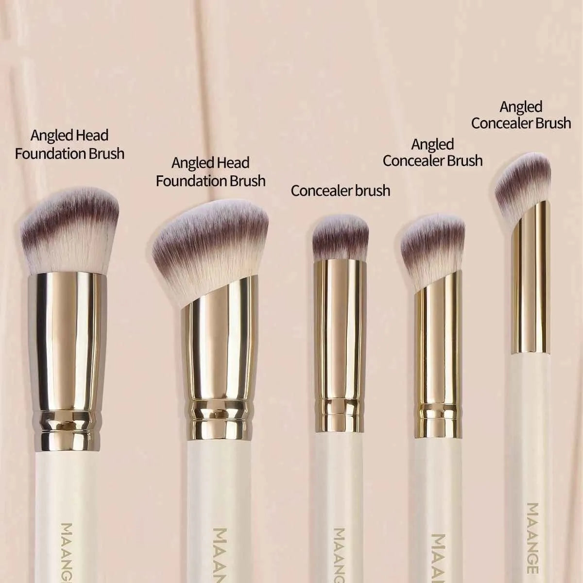 MAANGE five apricot coloured makeup brushes with angled blush brush on pink surface