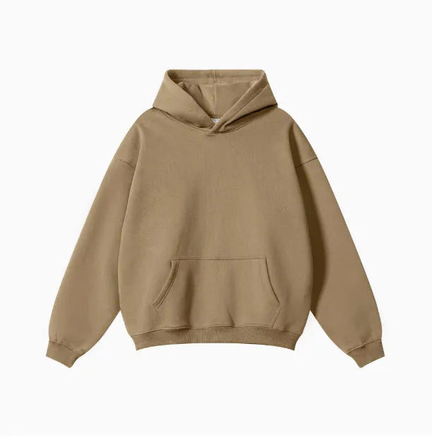 Man wearing a loose-fit grey terry cotton hooded sweater with drop-shoulder sleeves.