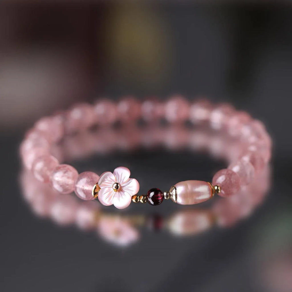 Strawberry quartz peach blossom bracelet with crystal flower charm and gemstone beads.