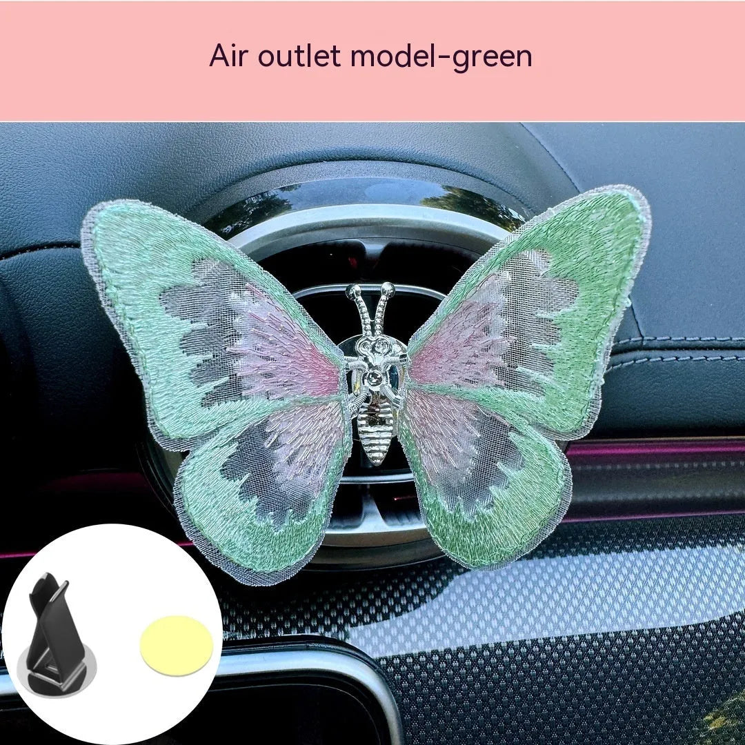 Moving embroidery butterfly decoration on car centre console air vent in pink fabric