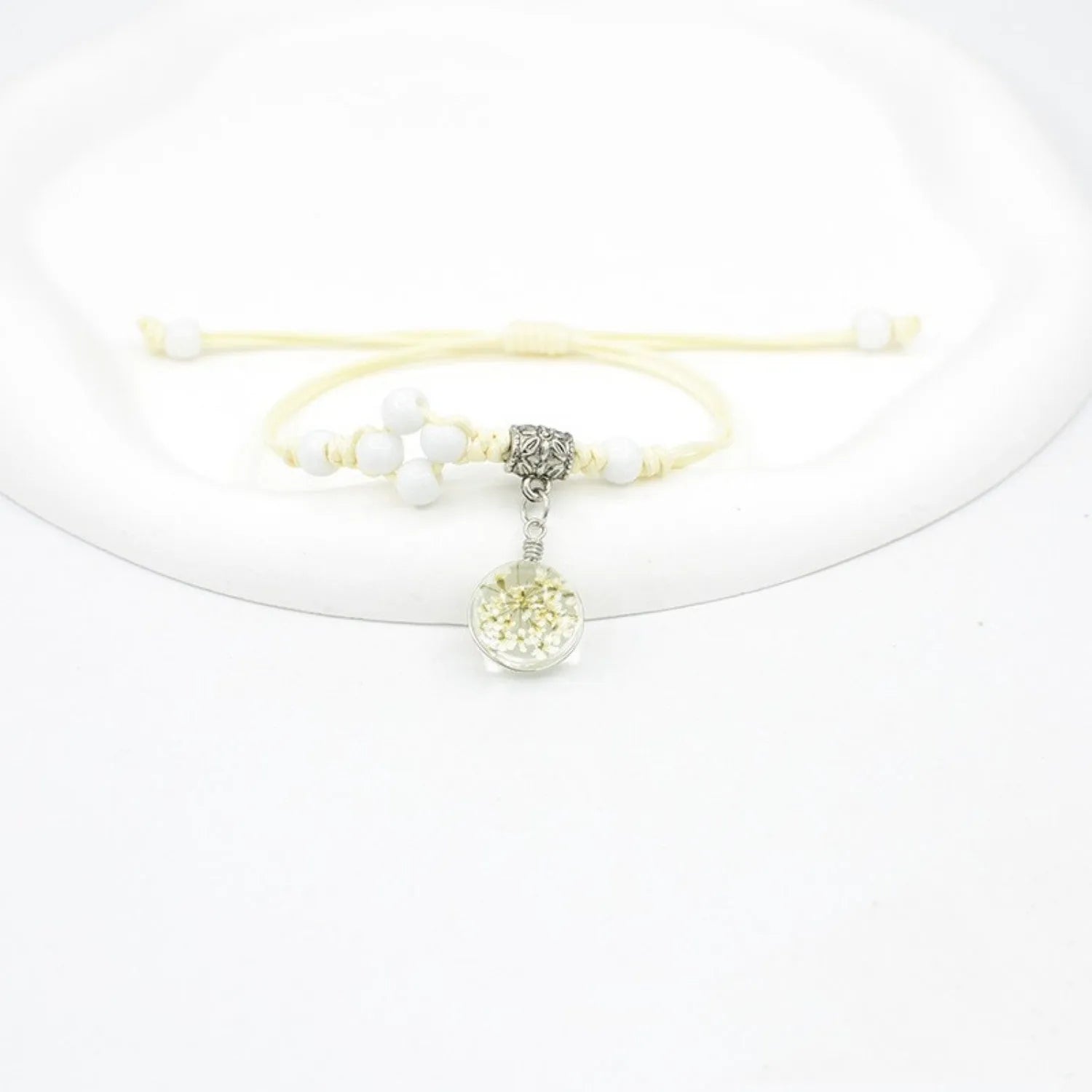 Hand-woven glass bracelet with 1.4cm beads containing real dried flowers in various colours